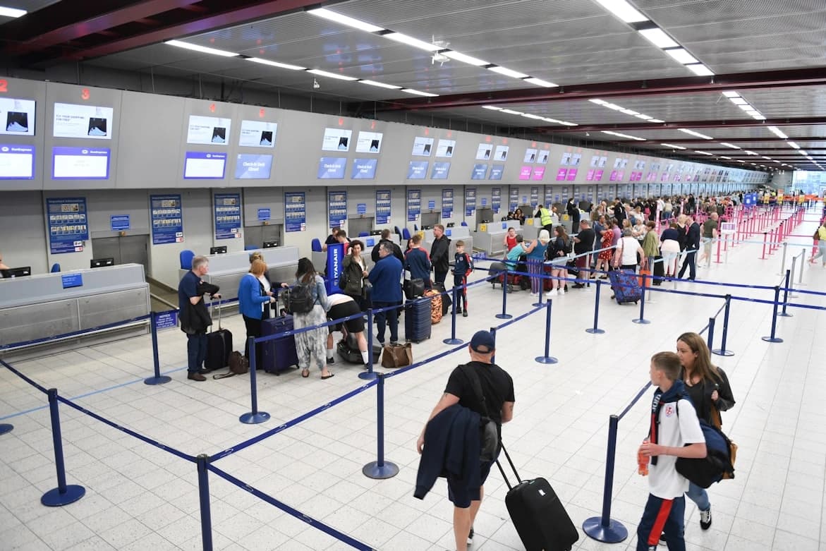 tsa precheck renewal in airport with people on boarding gates waiting in line